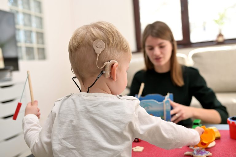 A,Boy,With,A,Hearing,Aids,And,Cochlear,Implants,Playing